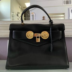 Versace black bag with gold finish. Lock and key.